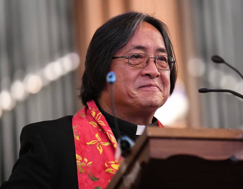a person in glasses and a red scarf