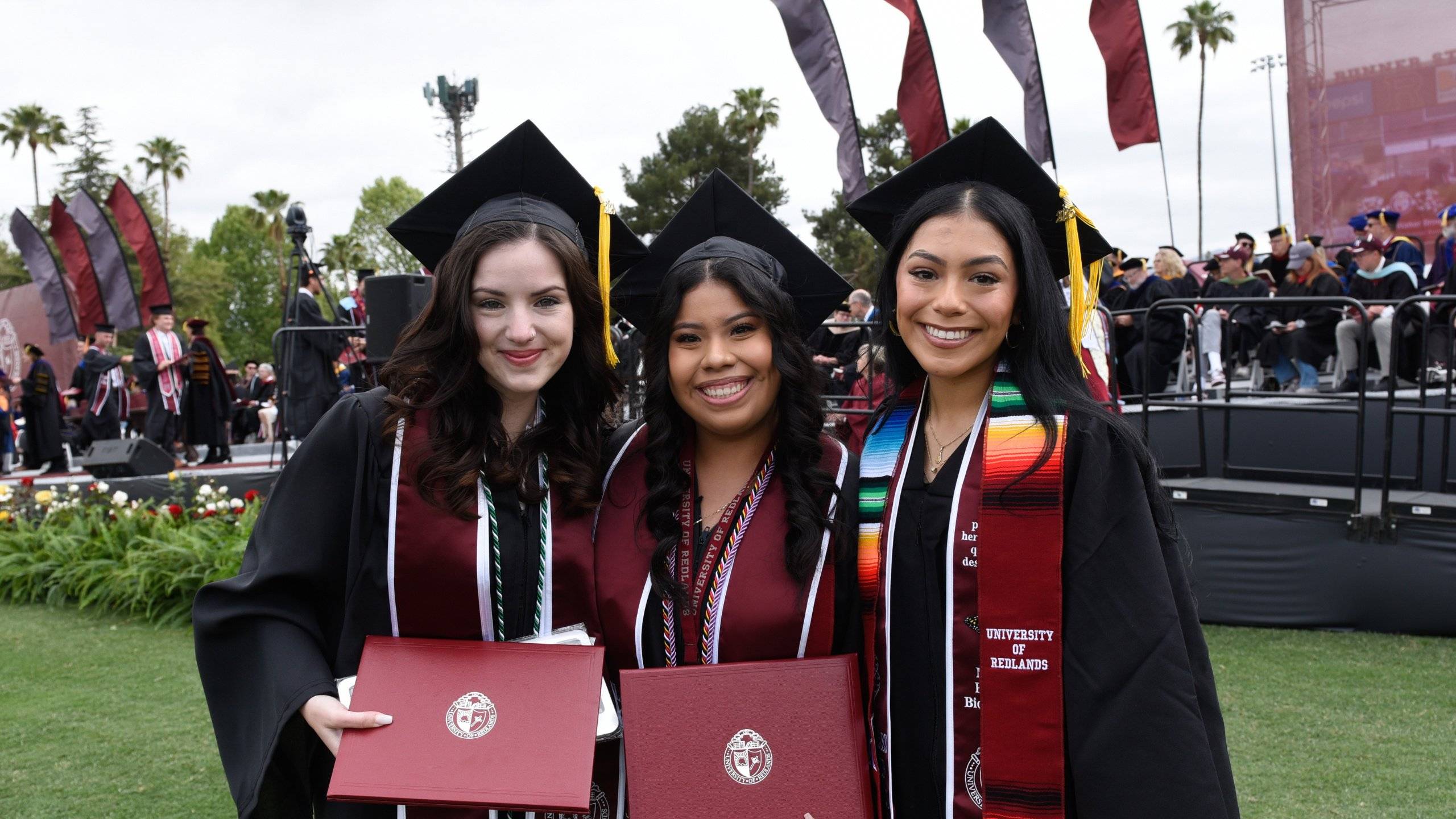 a group of women in graduation gowns and caps