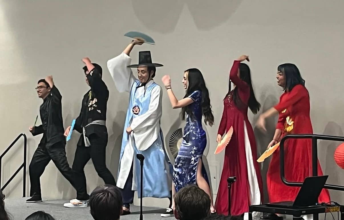 a group of people dancing on a stage