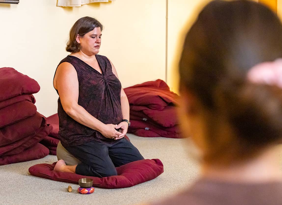 a person sitting on a pillow