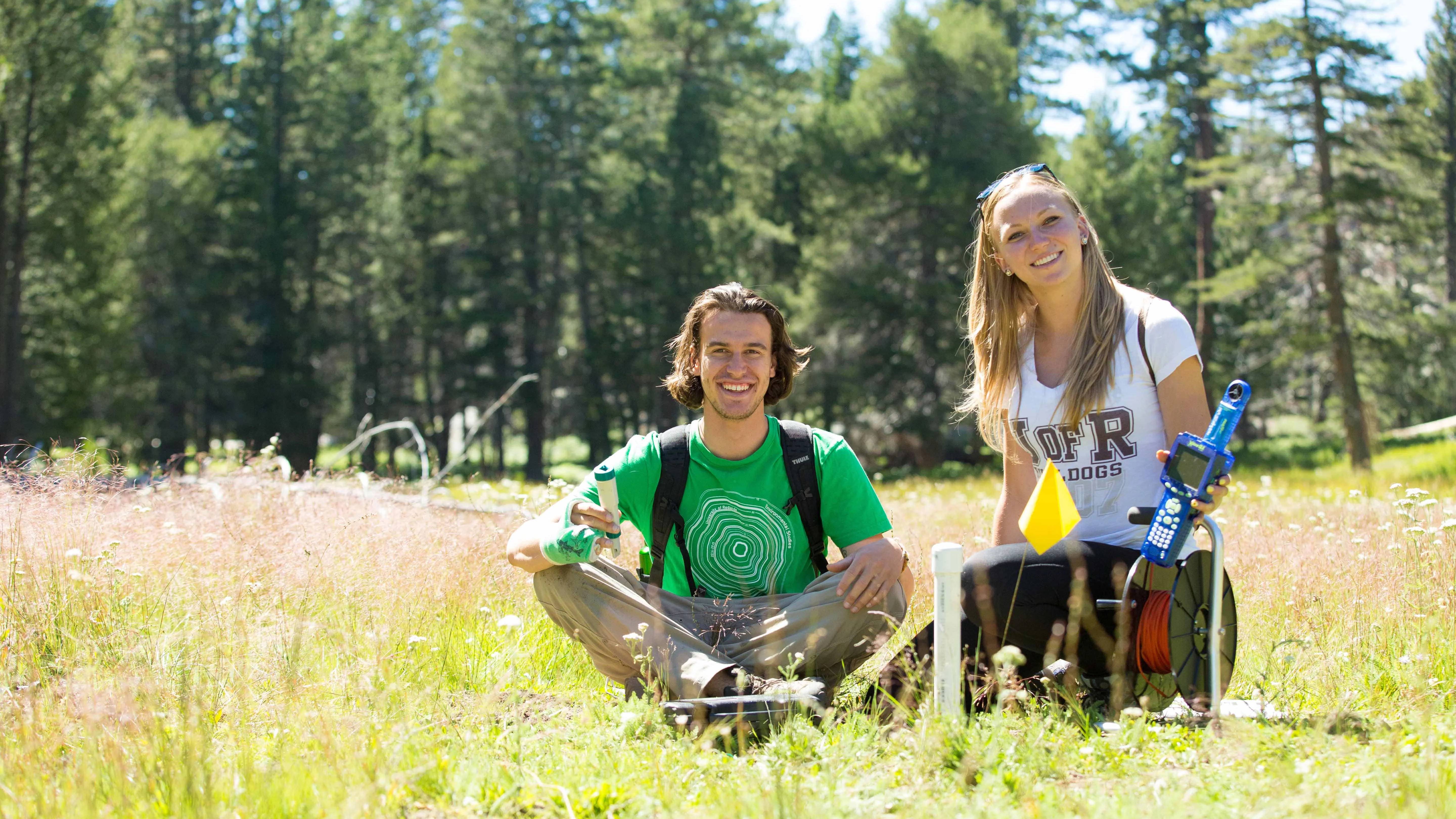a person and person sitting in a field