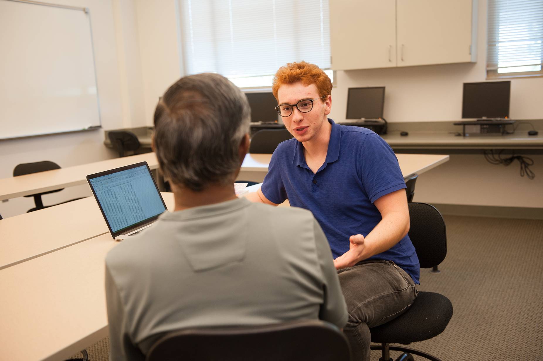 a person sitting in a chair talking to a person