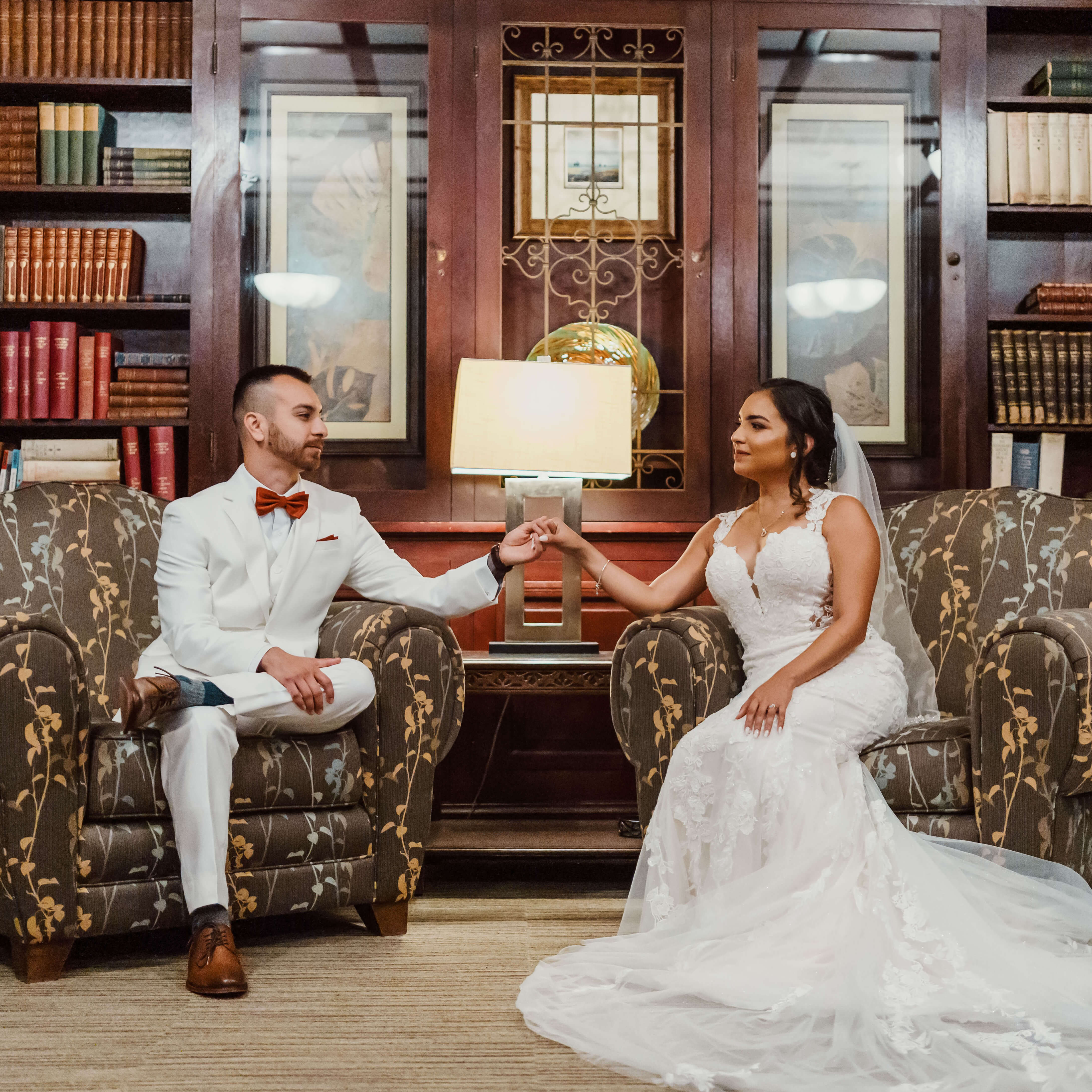 a person and person sitting in chairs holding hands