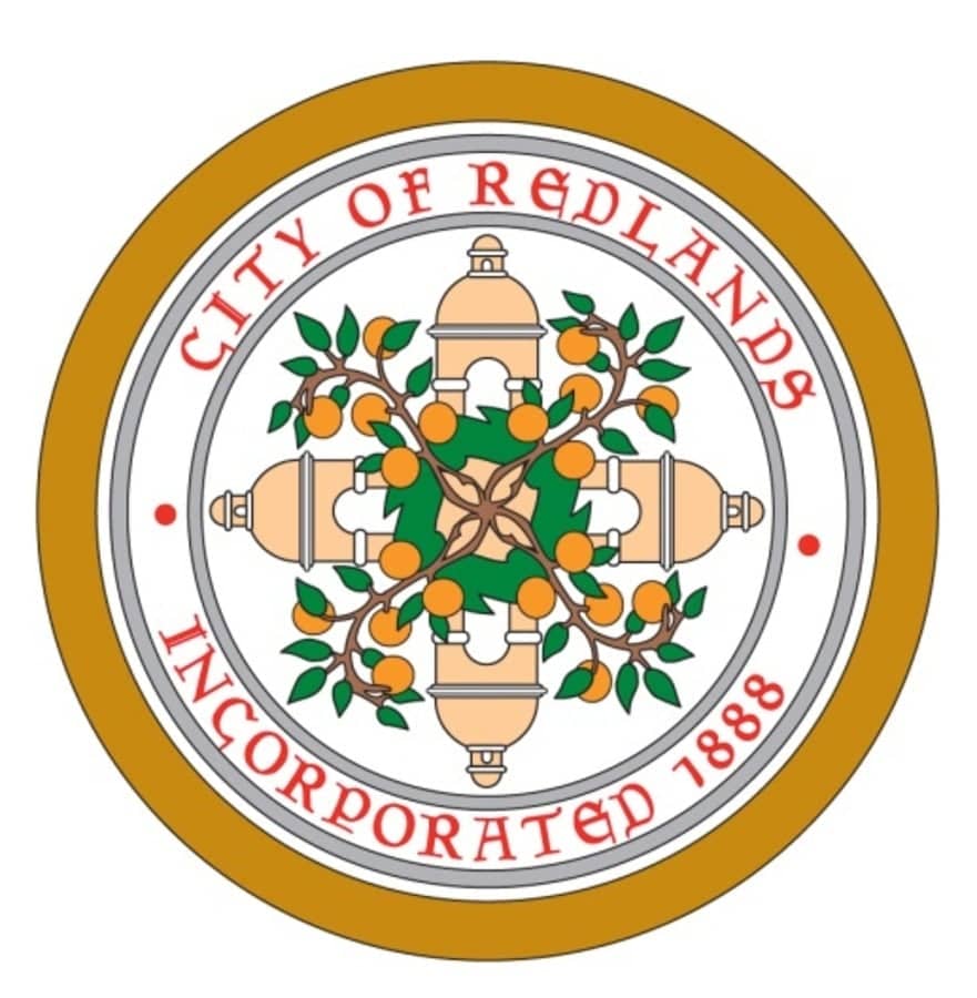 a circular logo with oranges and text