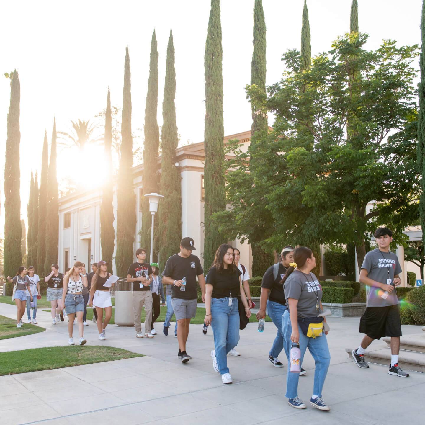 a group of people walking on a sidewalk