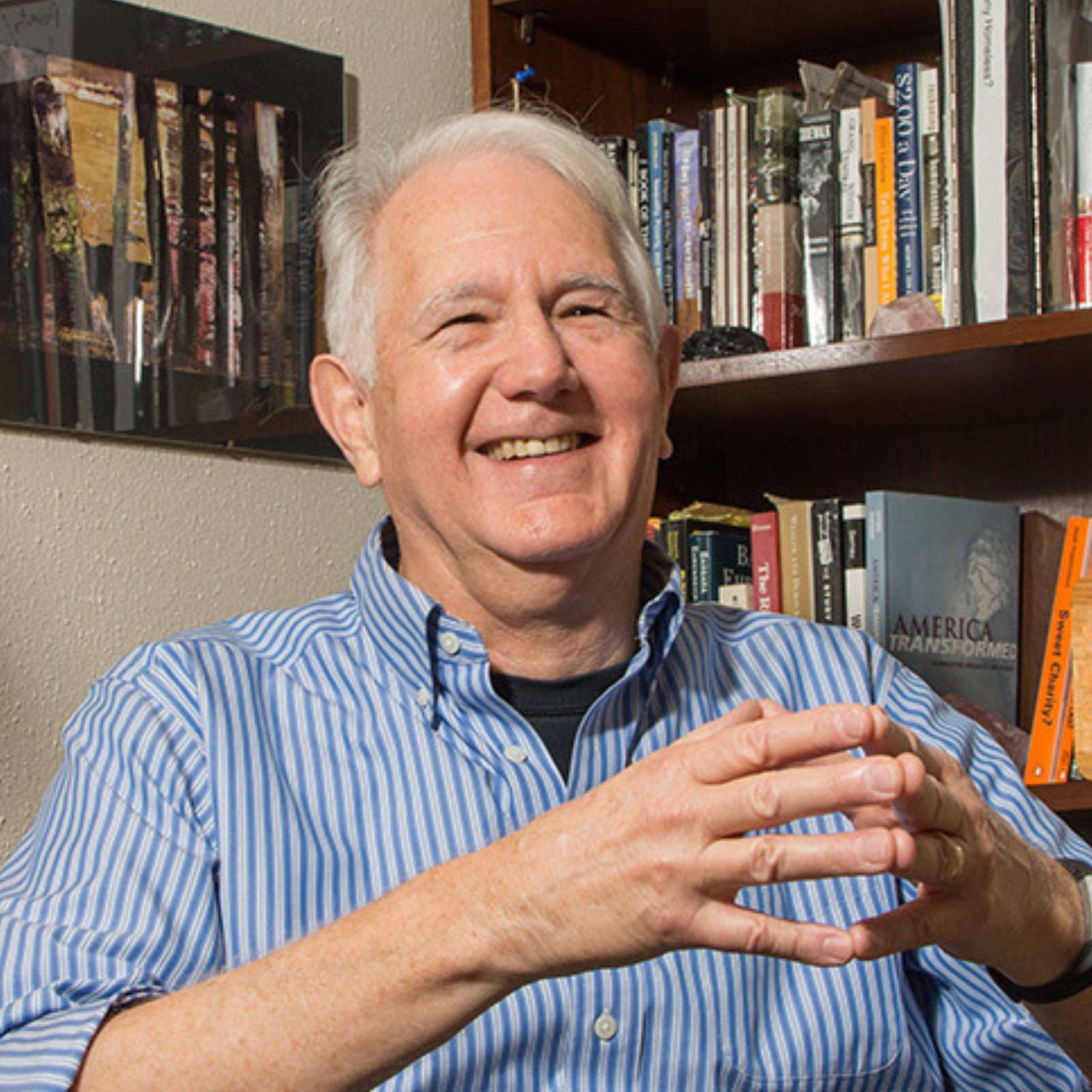 a person sitting in front of a bookcase