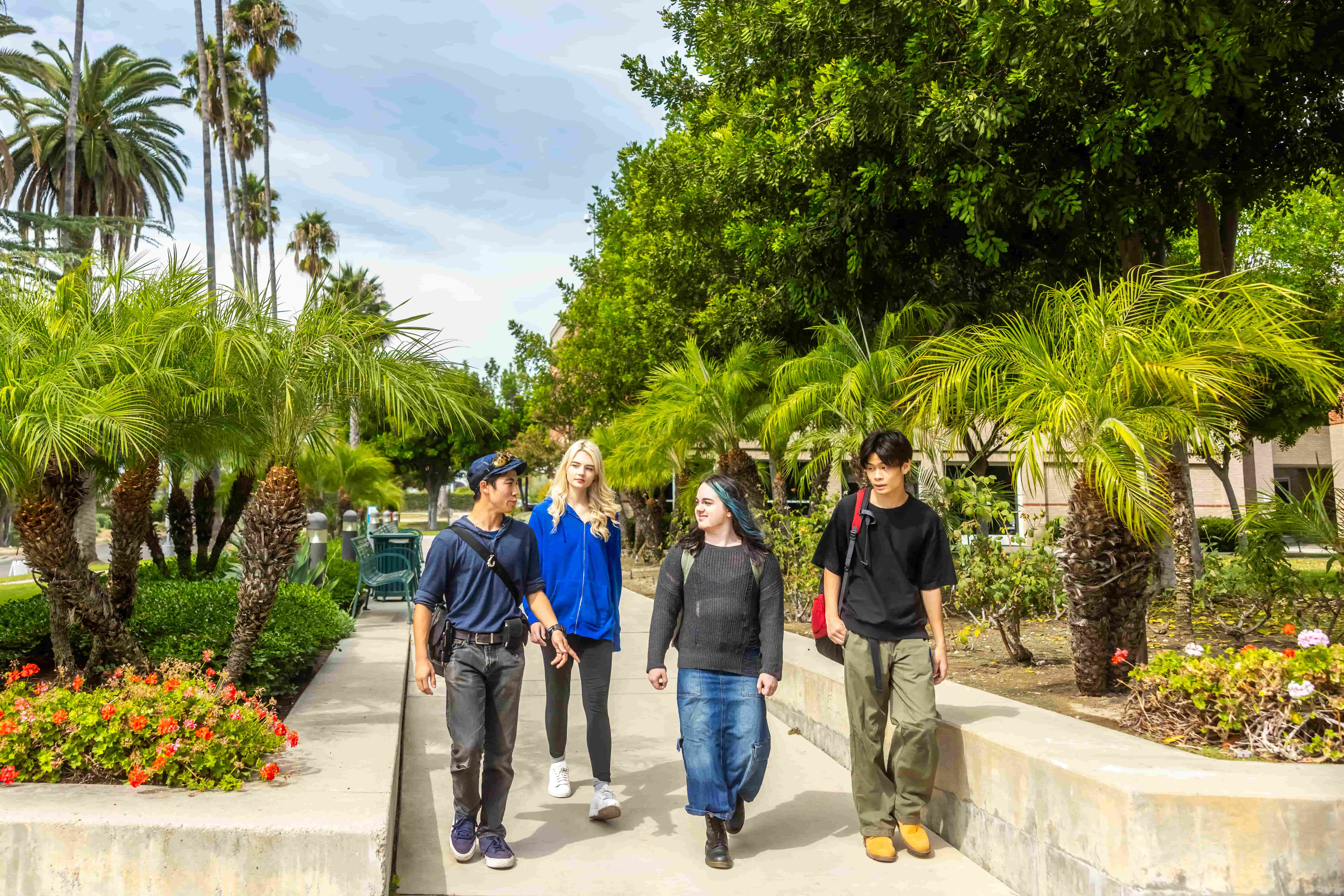 a group of people walking on a sidewalk