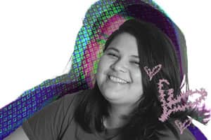 a person smiling with hearts drawn on her hair
