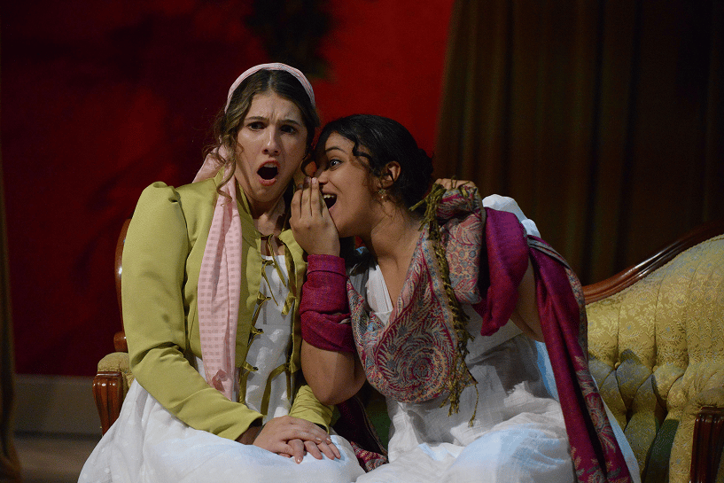 a person whispering to another person