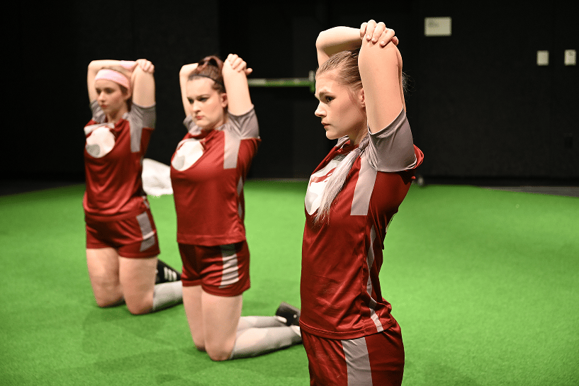 a group of women in sports uniforms stretching