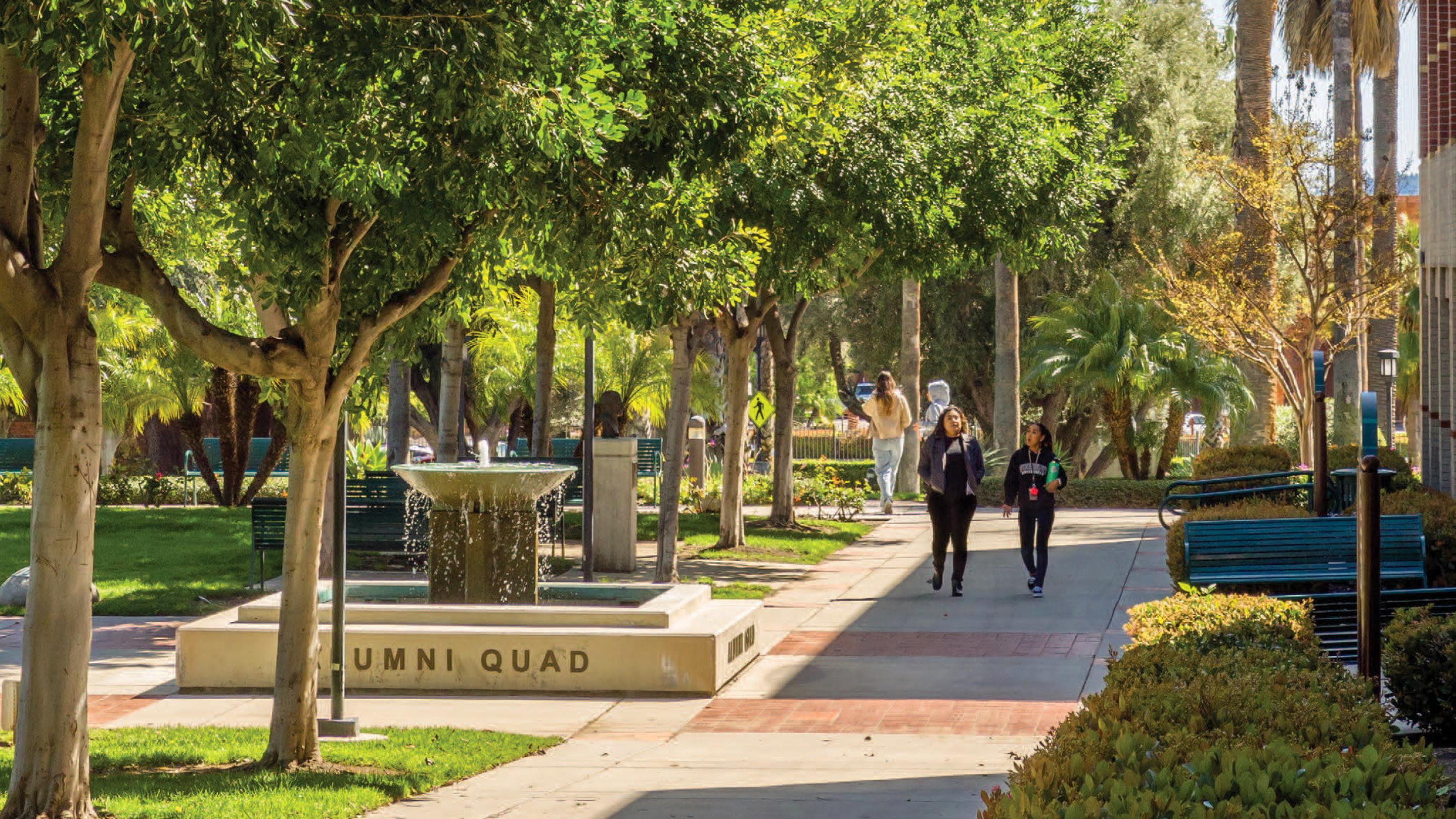 Two students walking and talking across the Woodbury Campus in Burbank.
