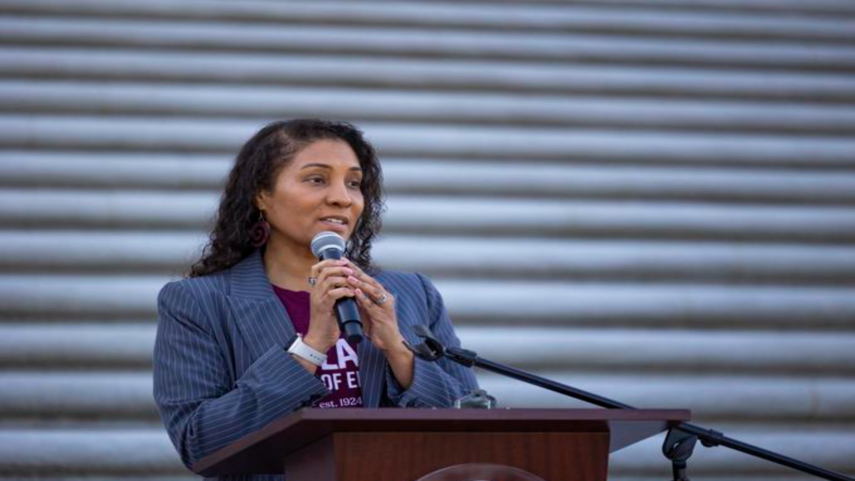 a woman speaking into a microphone