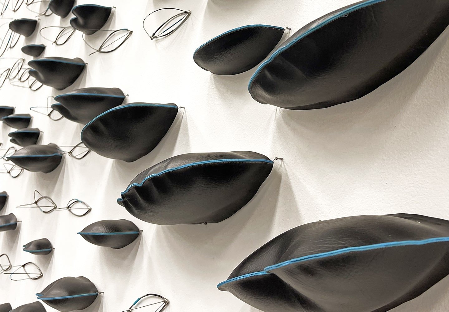 a wall with black pillows