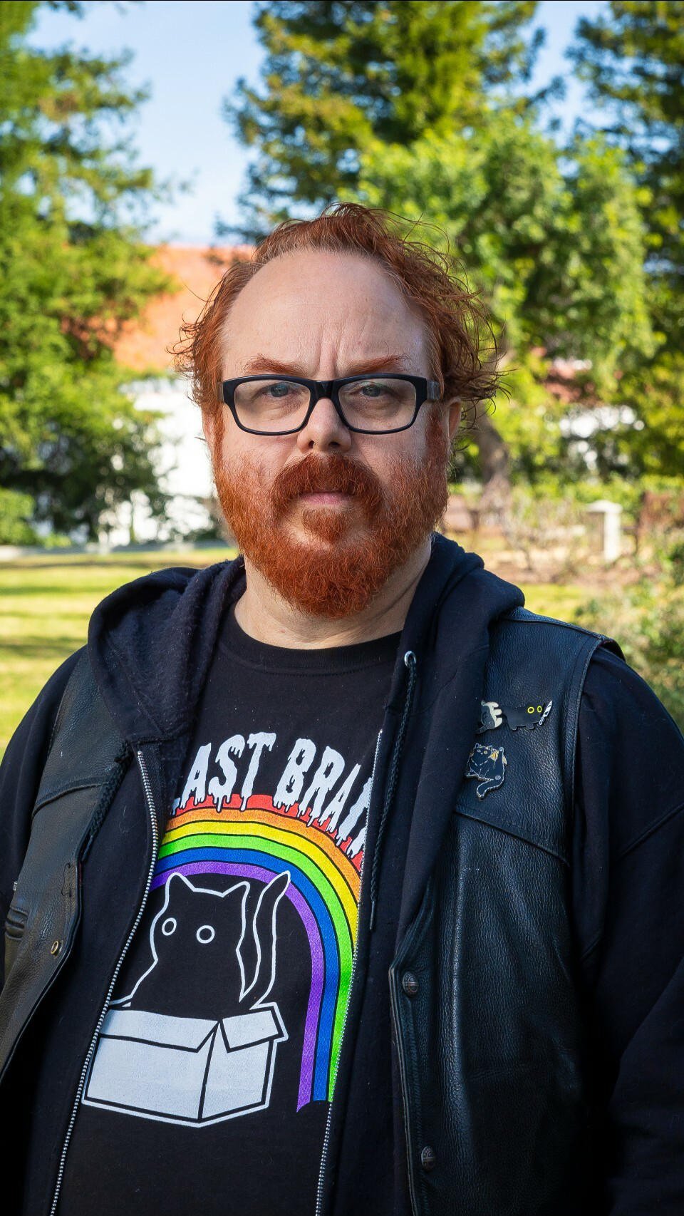 a man with red hair and beard wearing glasses