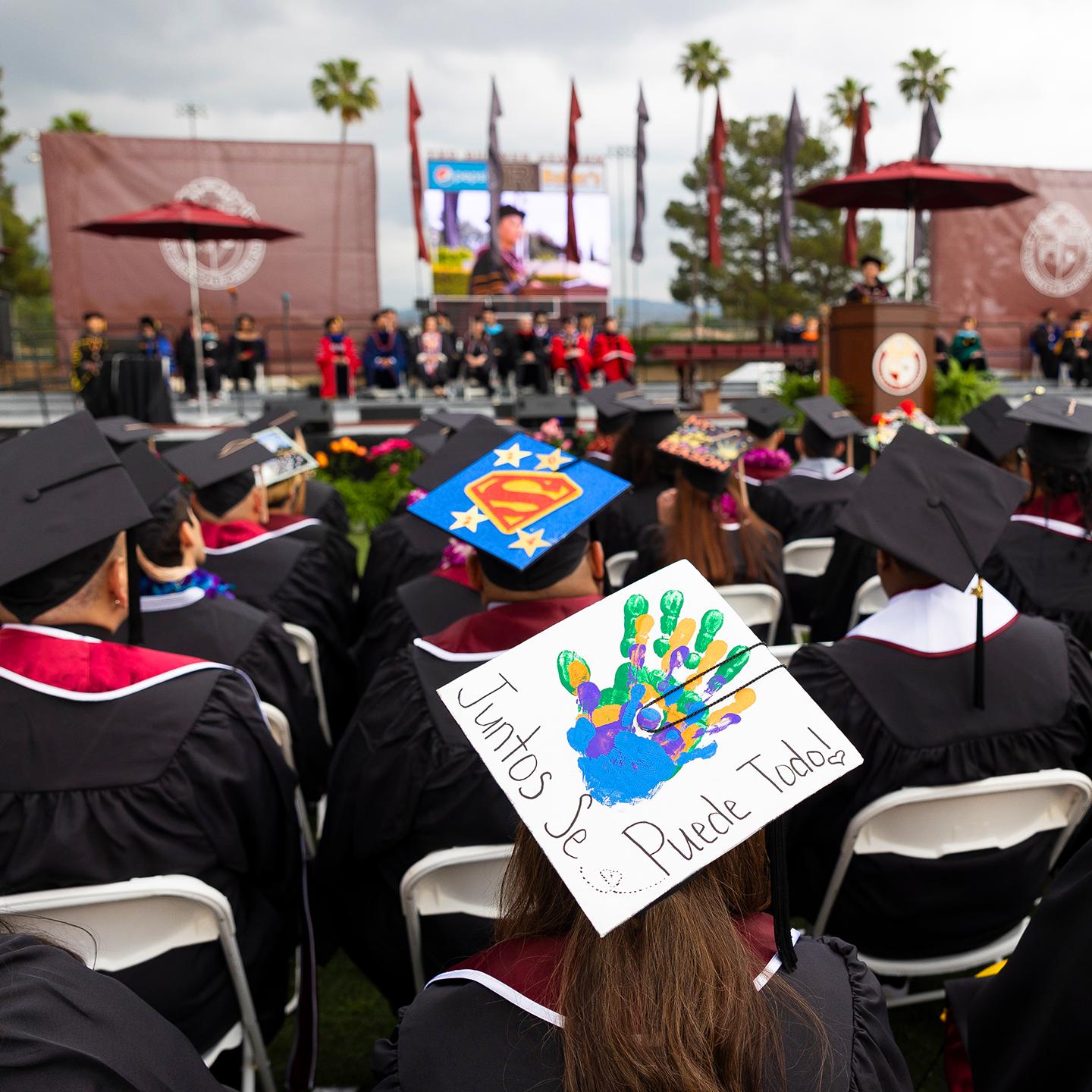 a group of people in graduation gowns and caps