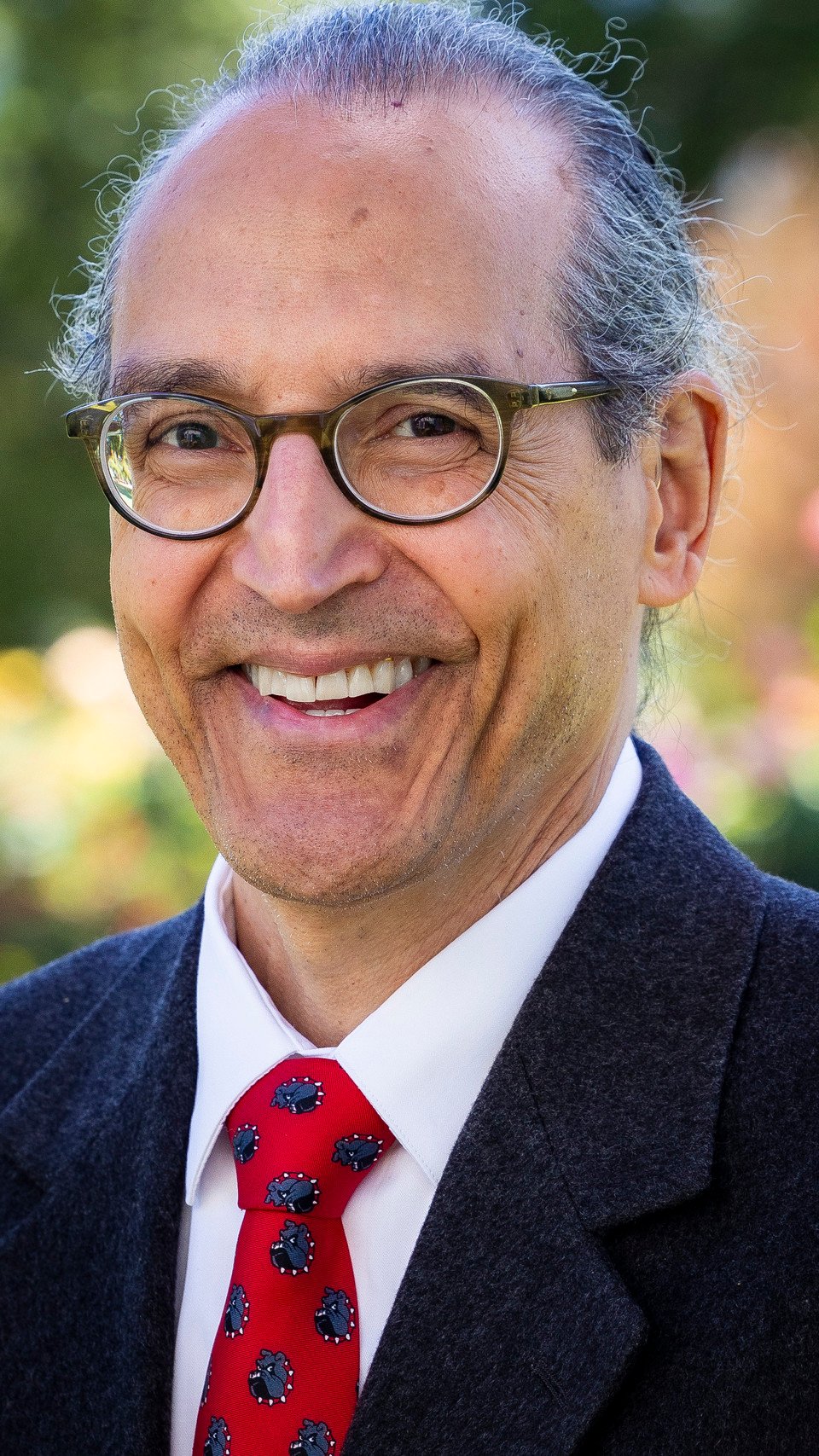 a man wearing glasses and a suit