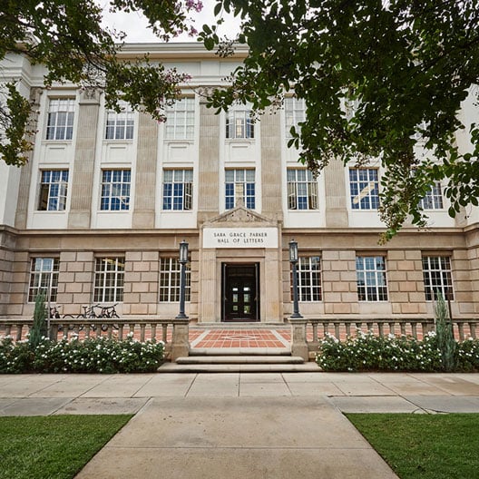 a building with trees and grass
