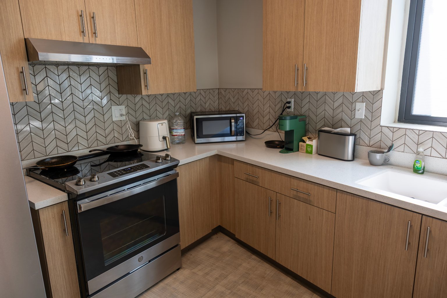 a kitchen with wood cabinets and a stove