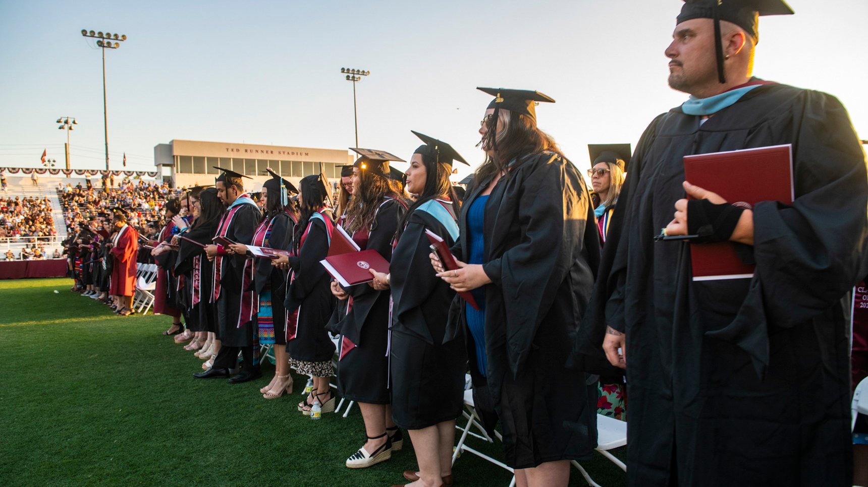 a group of people in graduation gowns and caps