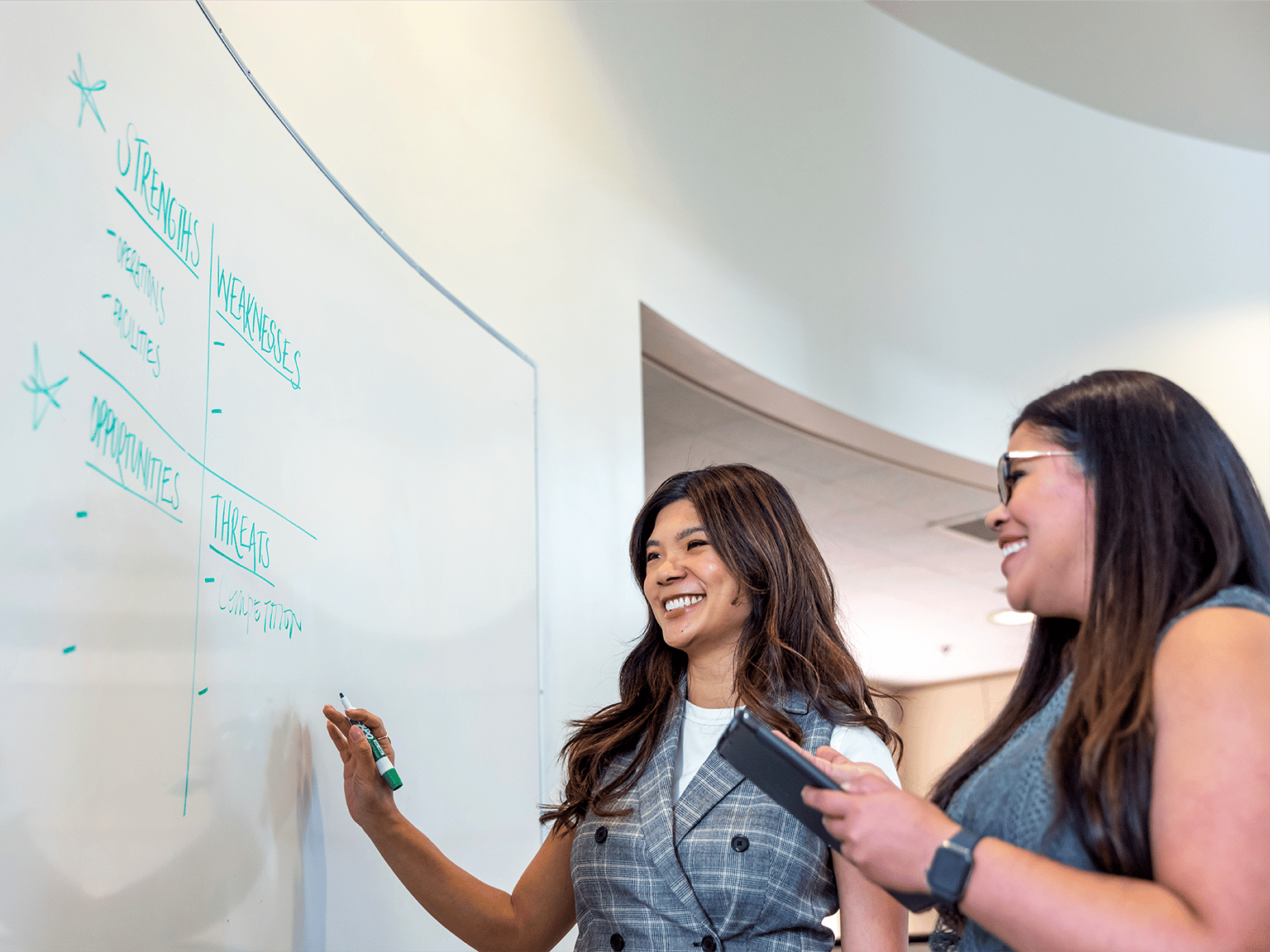 a group of women writing on a whiteboard