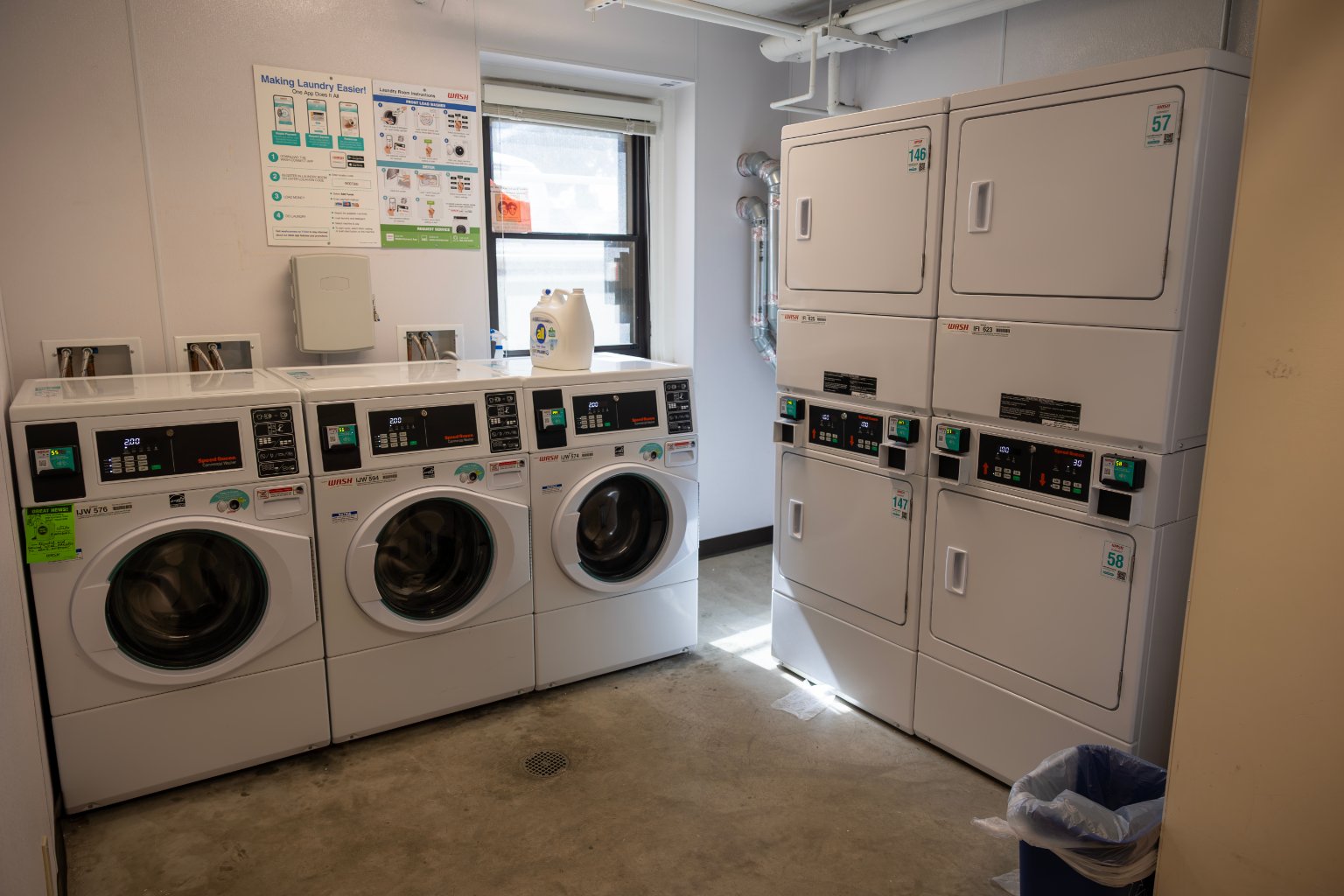 a laundry room with several washing machines
