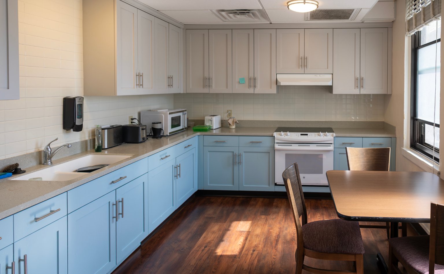 a kitchen with a table and chairs
