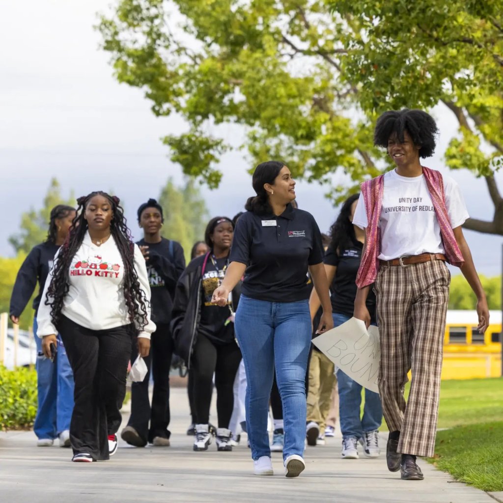 a group of people walking on a sidewalk