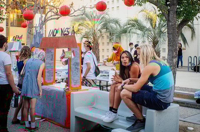 a group of people sitting on a bench outside