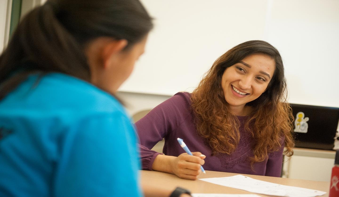 a woman smiling at another woman