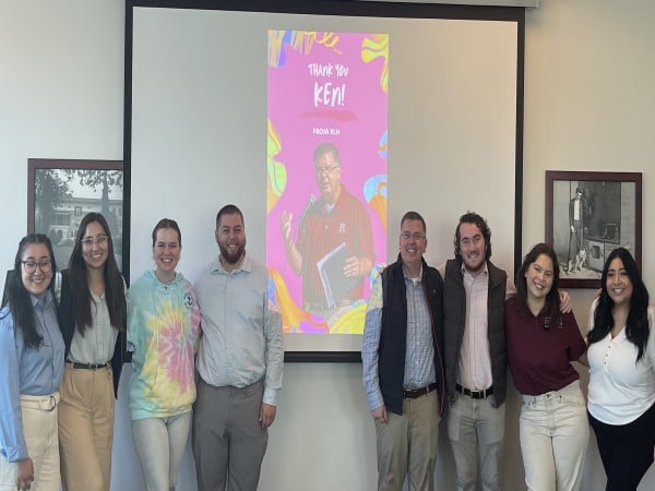 a group of people standing in front of a projector screen