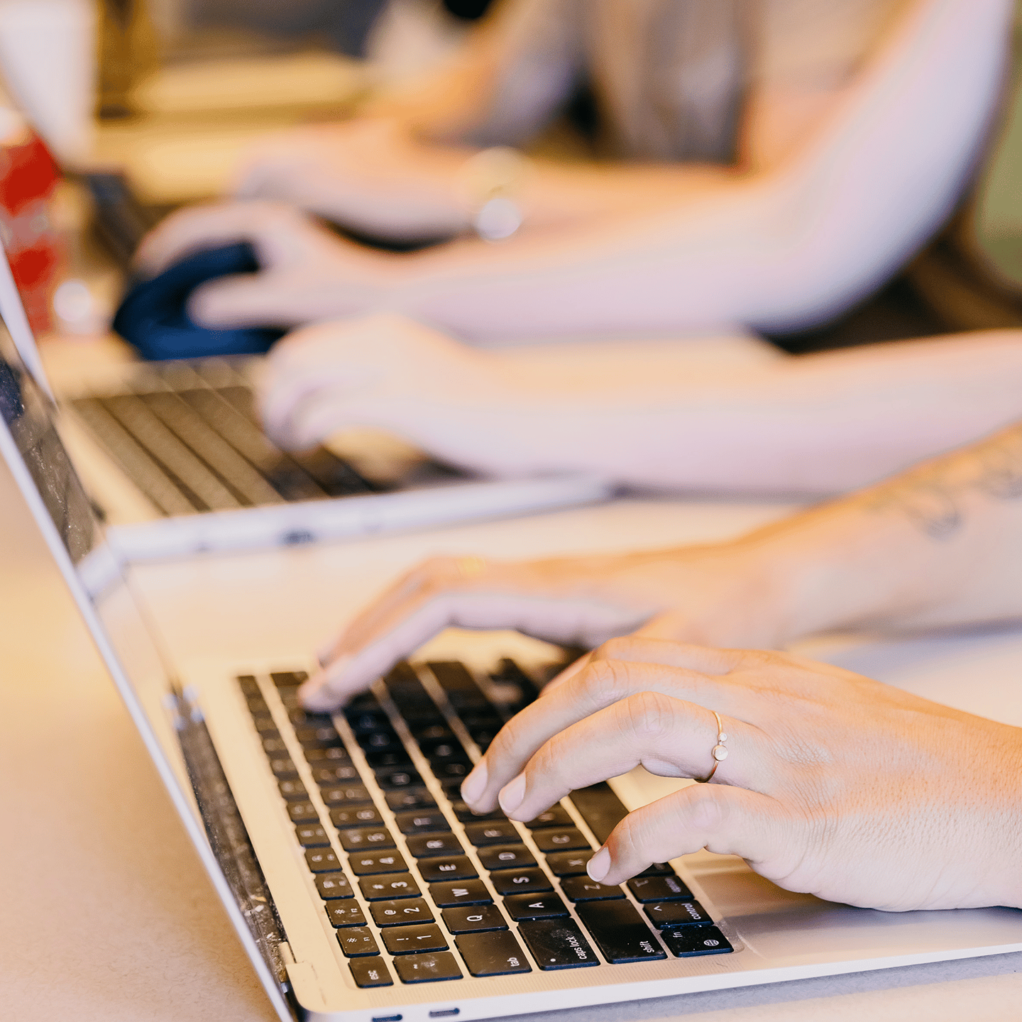 a person's hands on a laptop keyboard