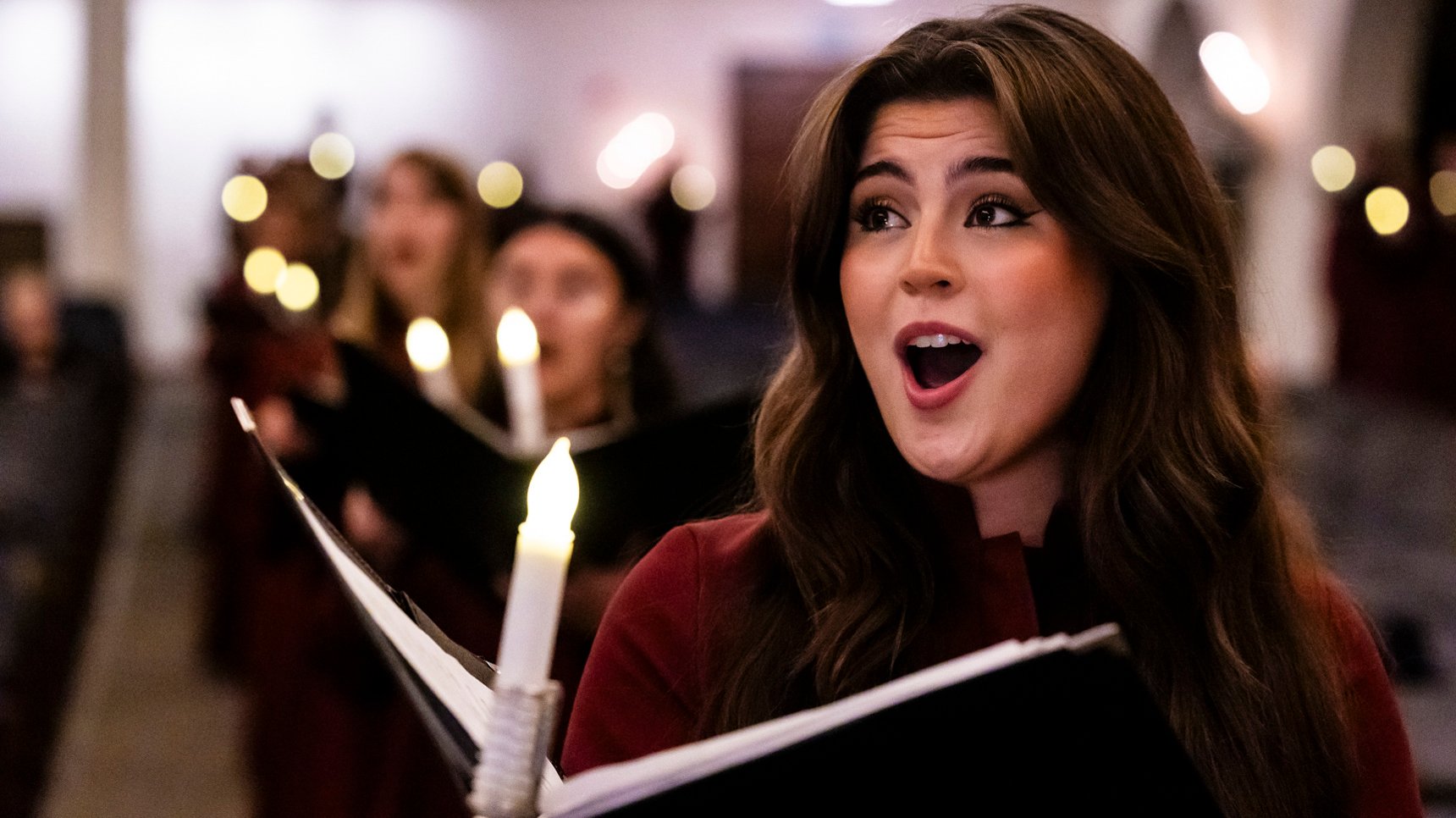 a woman singing in a choir