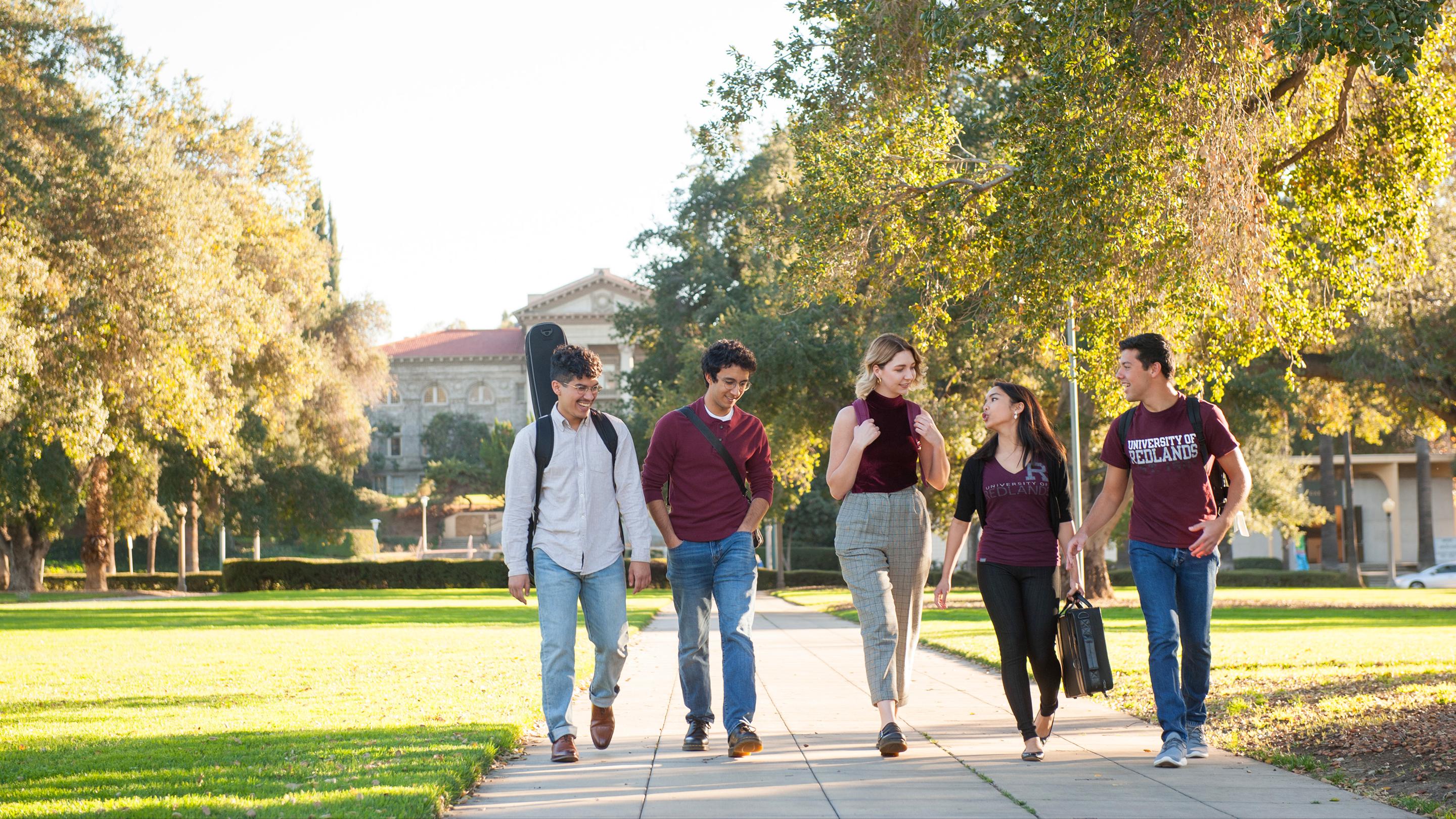 a group of people walking on a sidewalk
