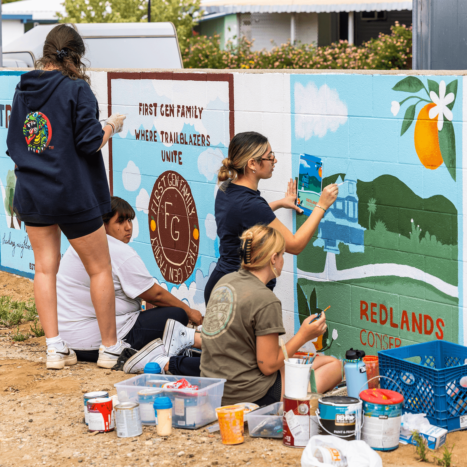 A group of students painting a mural for a community service project