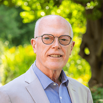 a man wearing glasses and a suit