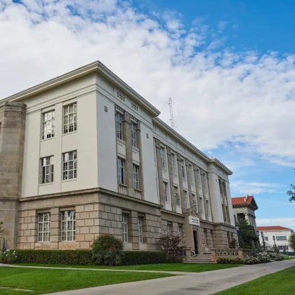 a large building with grass and a lawn