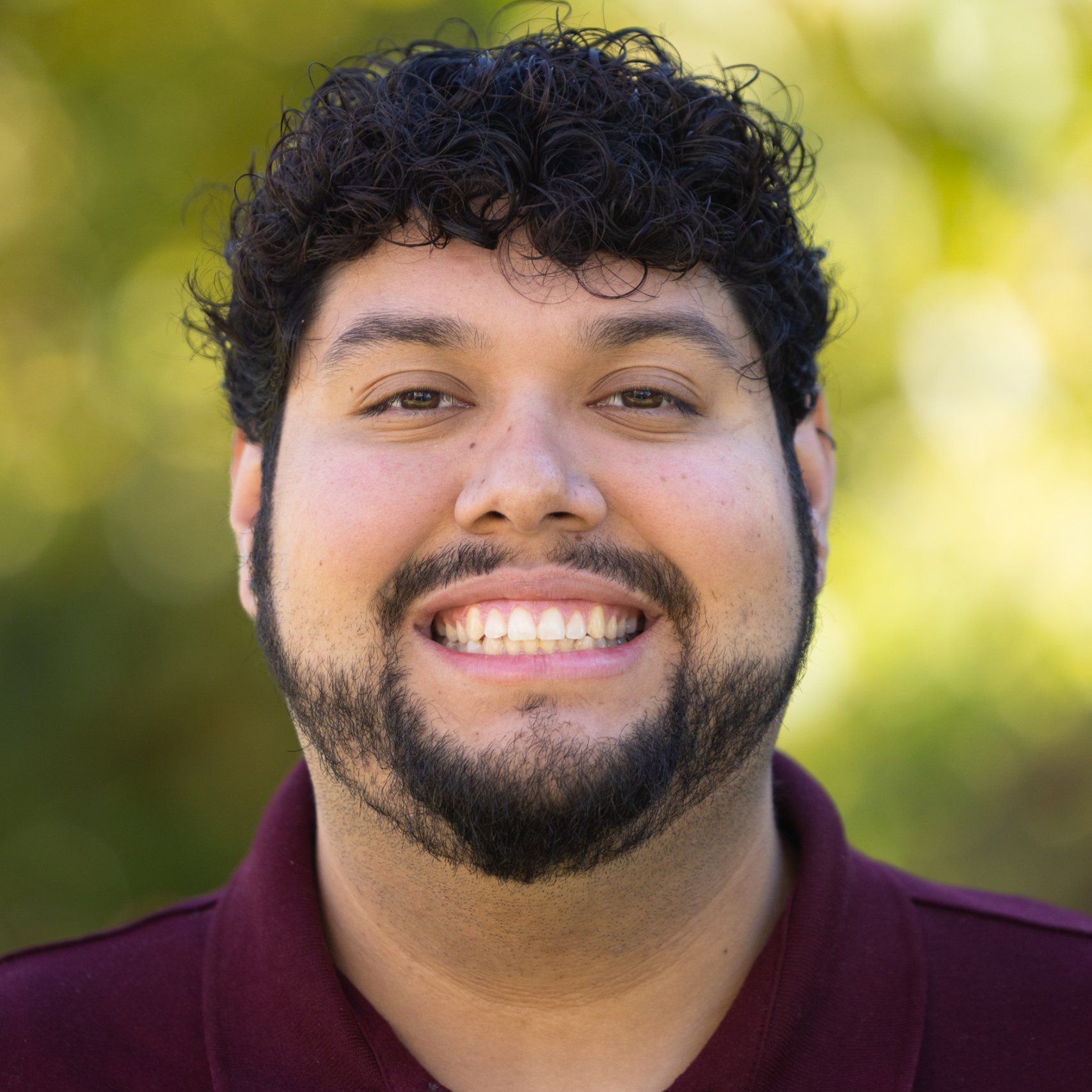 a man with a beard smiling