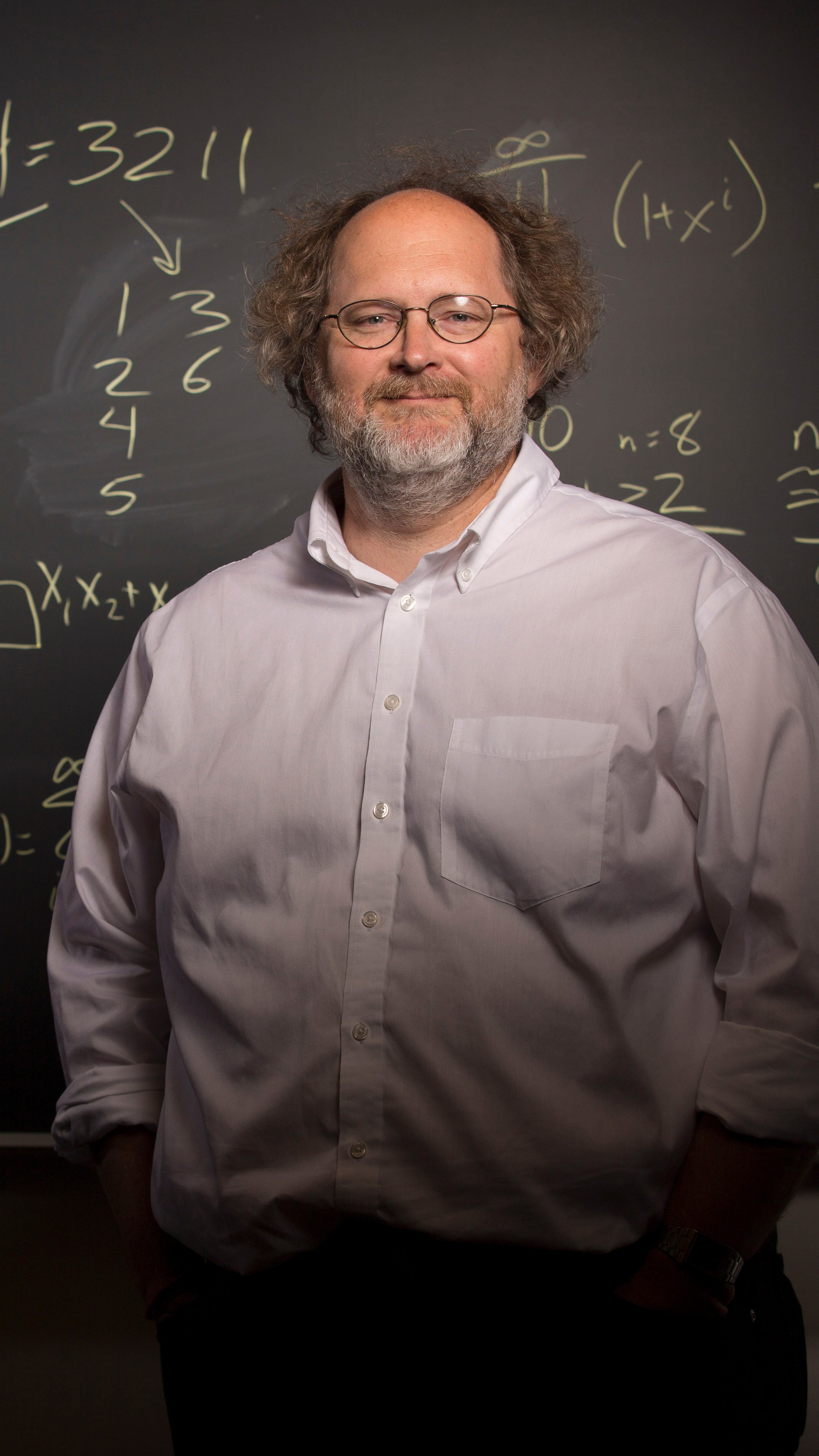 a man standing in front of a chalkboard