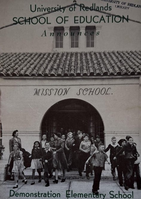 a group of children in front of a mission school