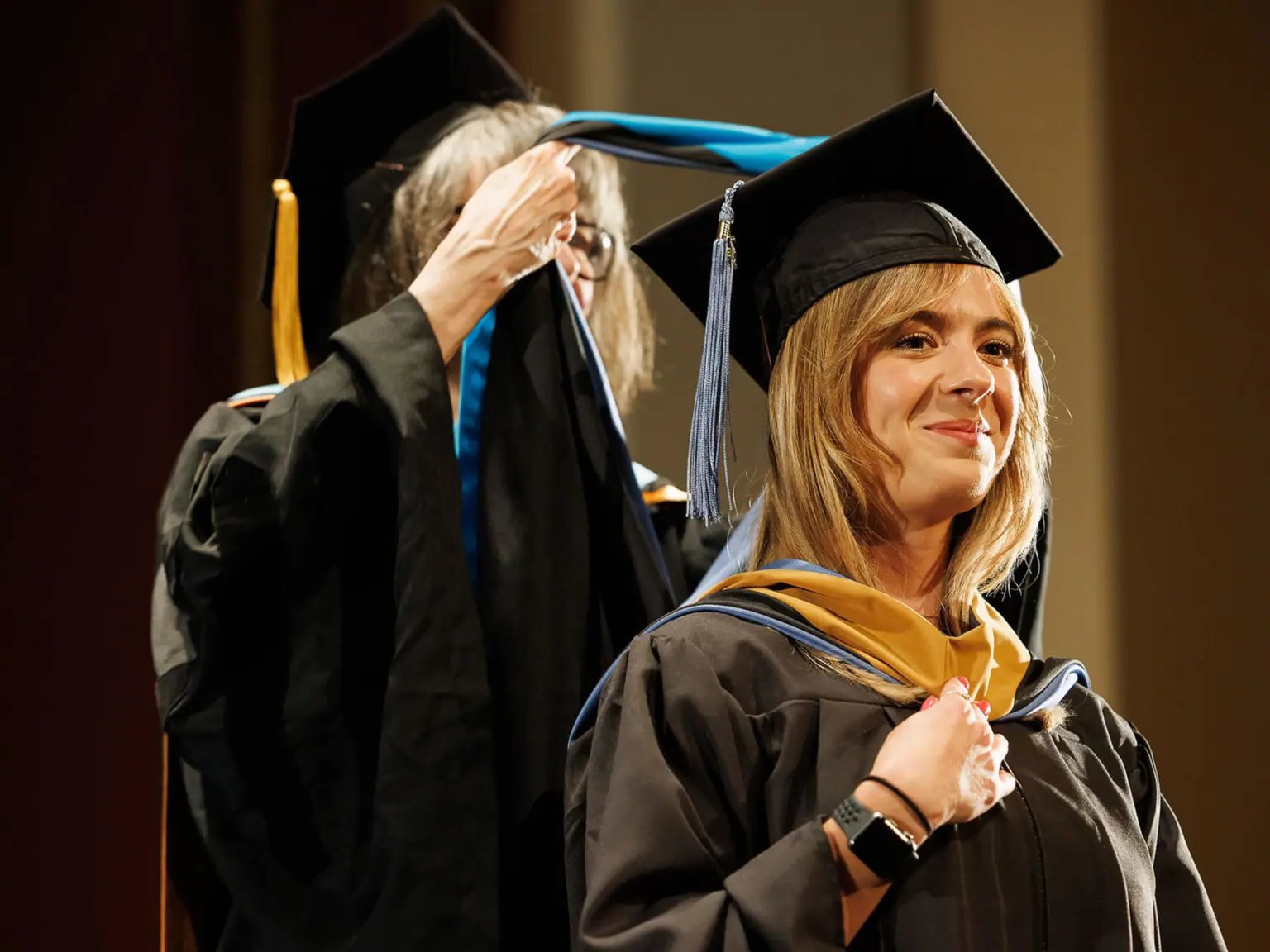 a woman in a graduation gown and cap
