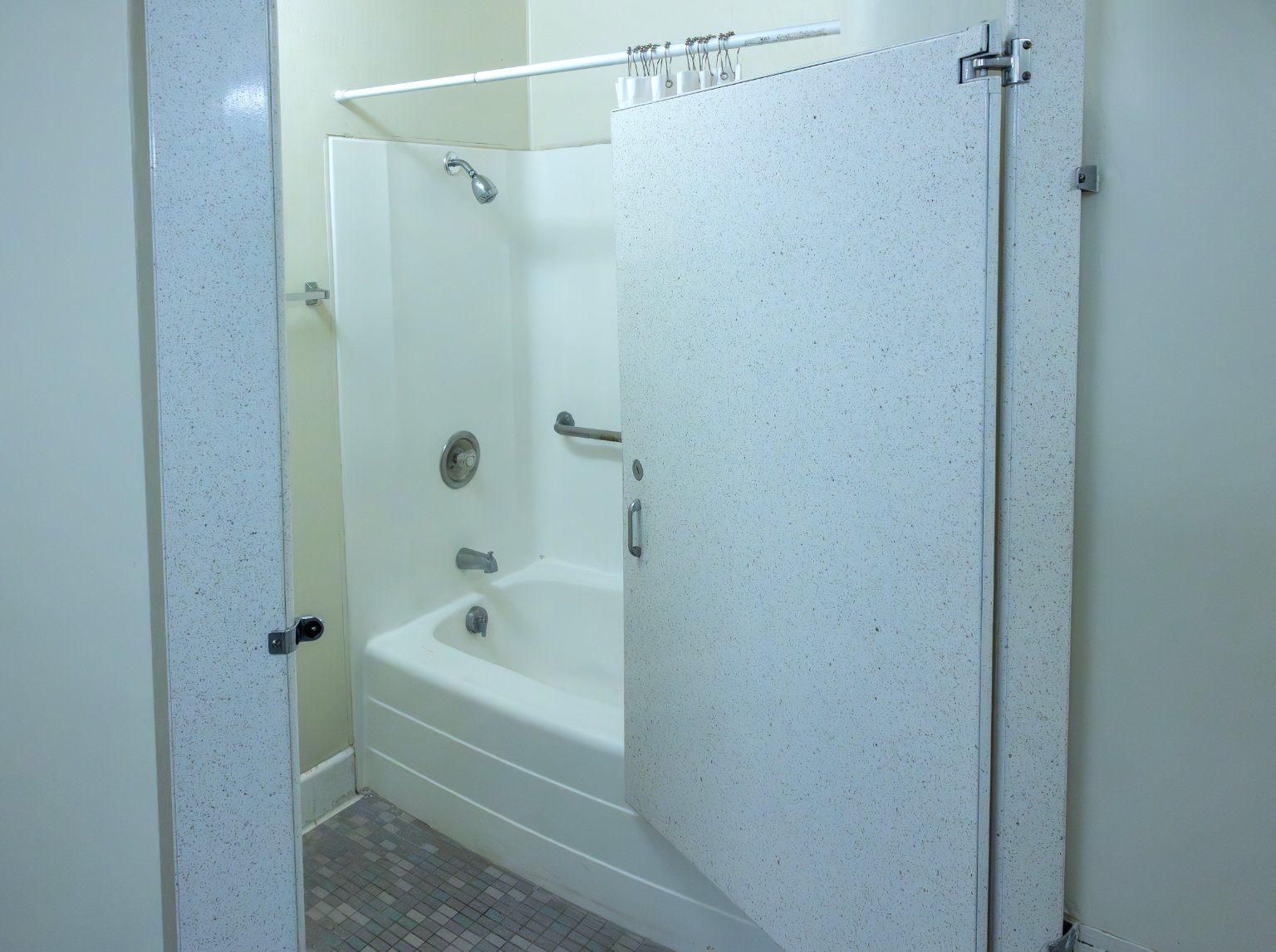 a shower stall with a door open
