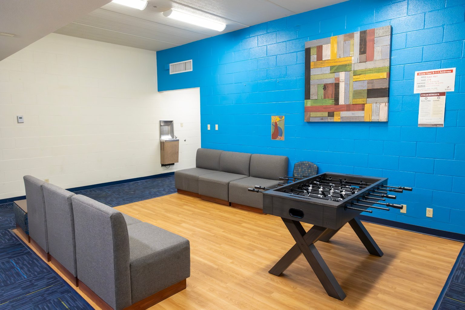 a room with a couch and foosball table