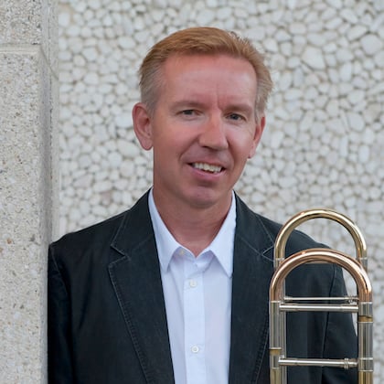 a person standing next to a trumpet