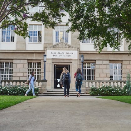 a group of people walking into a building