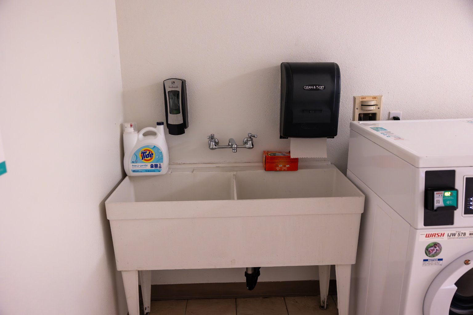 a sink with soap dispenser and soap dispenser