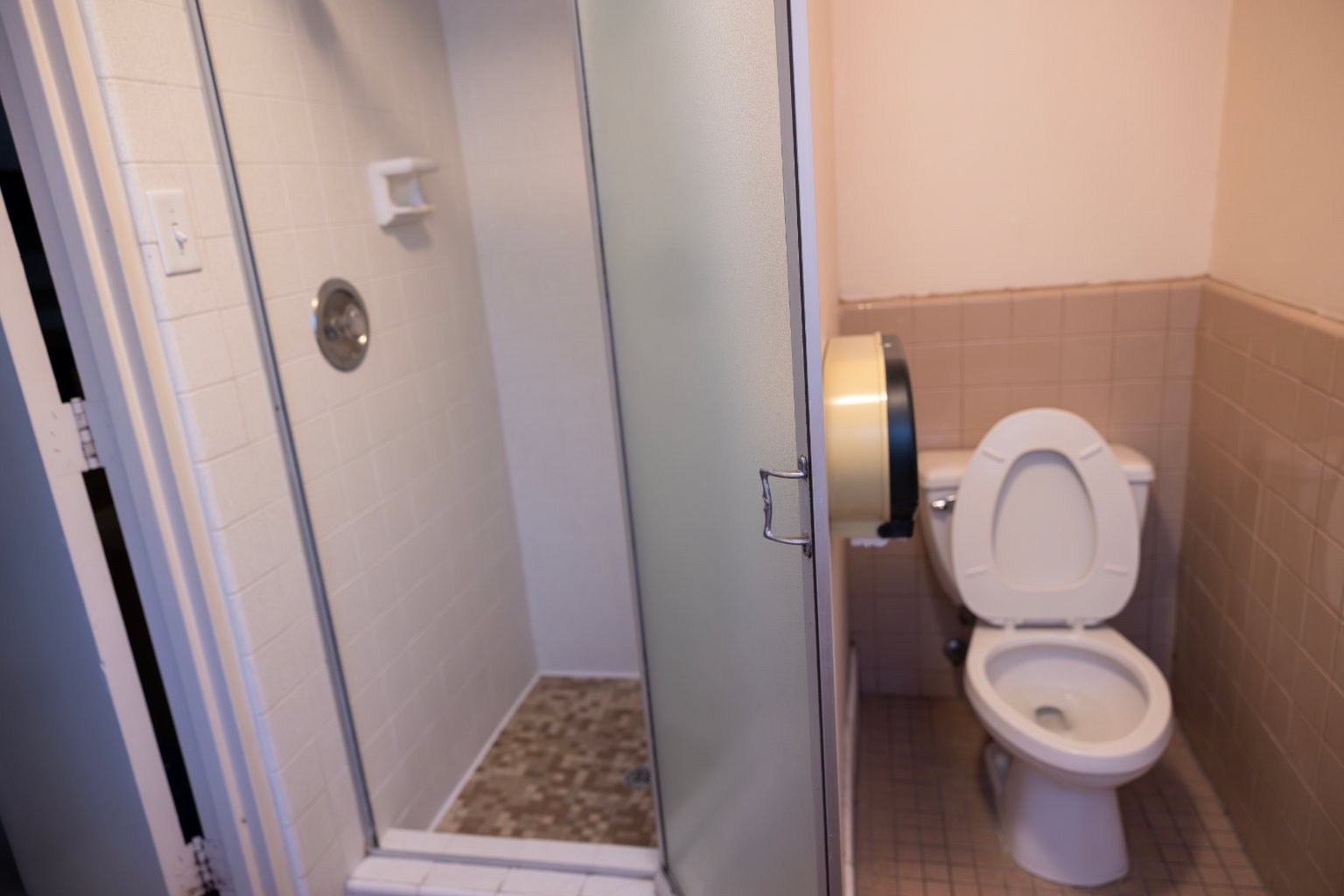 a bathroom with a shower and toilet