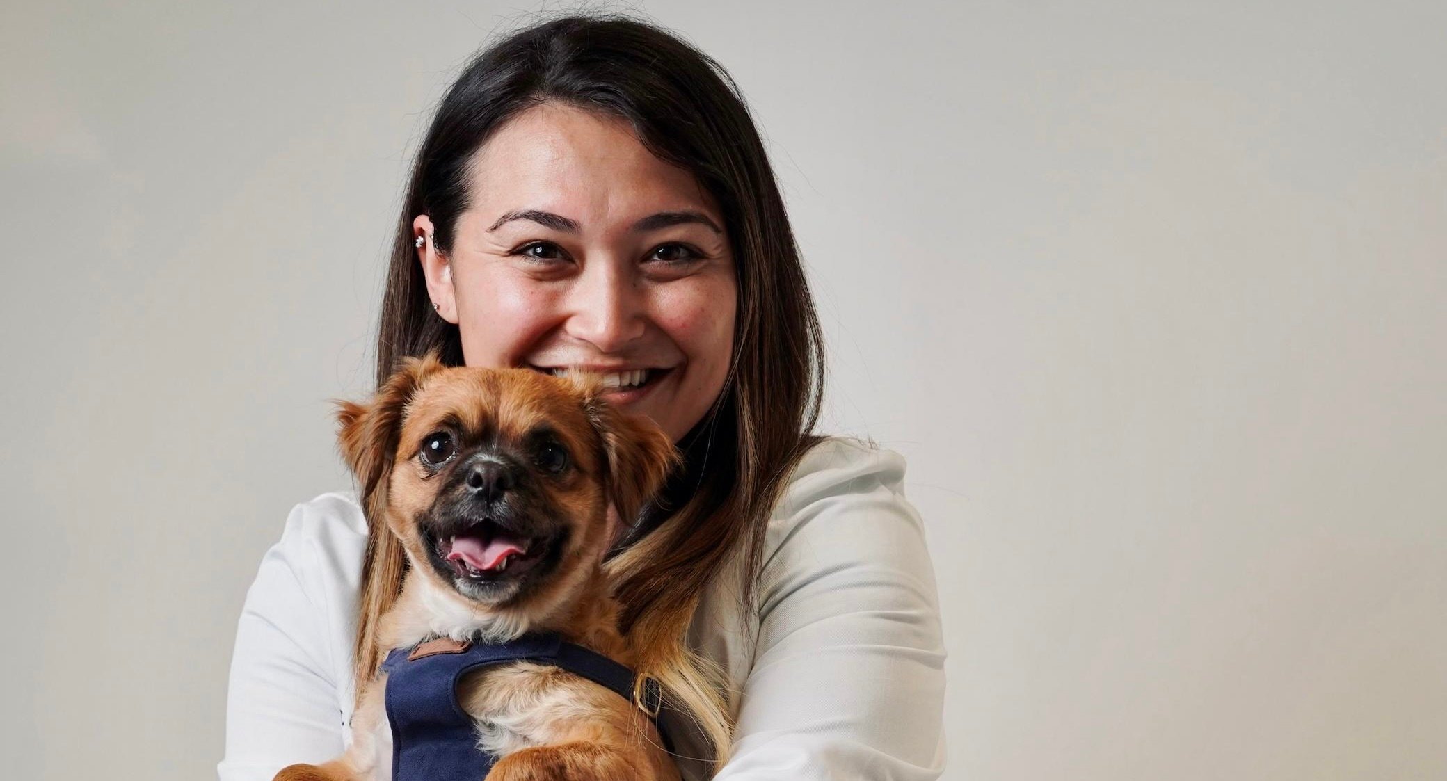 a woman holding a dog