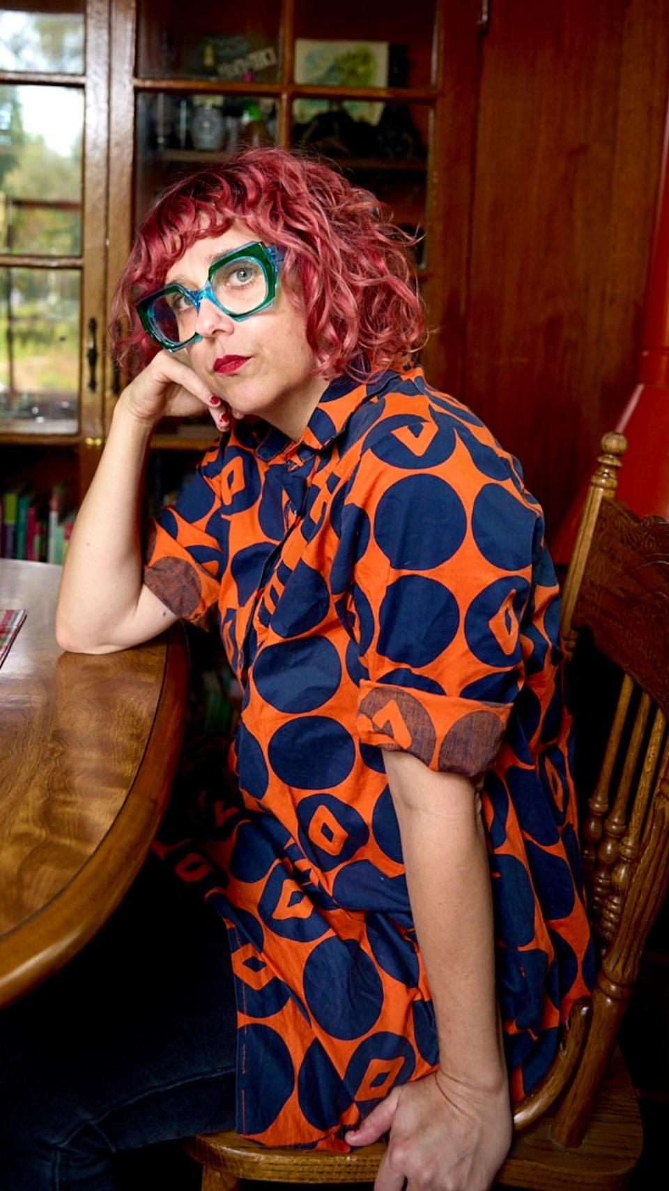a woman sitting at a table with her hand on her face