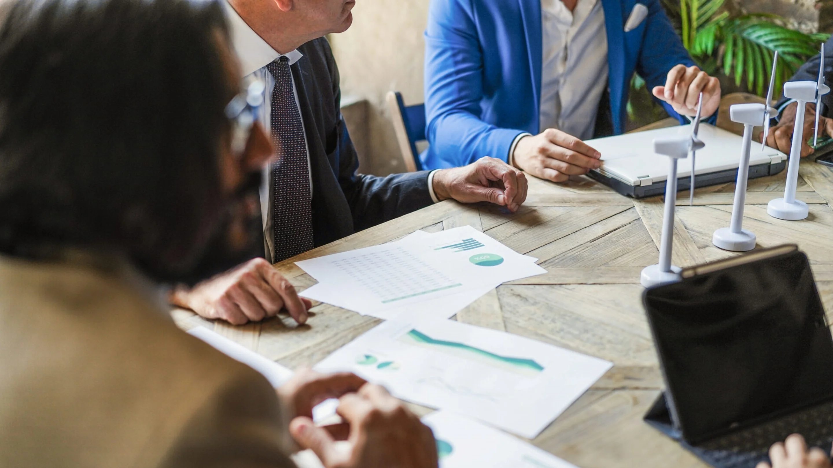 a group of people sitting at a table with papers