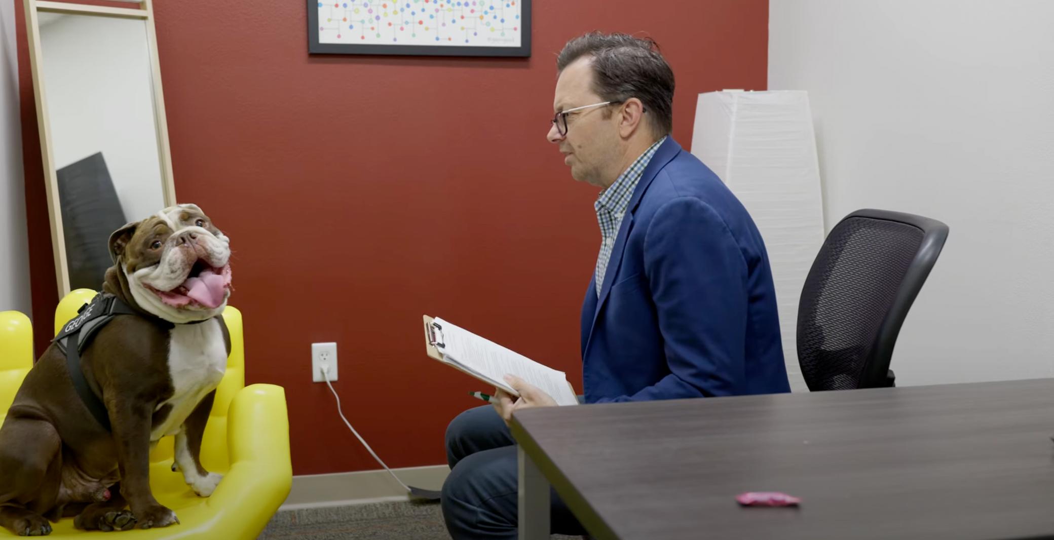 a man in a blue suit holding a clipboard